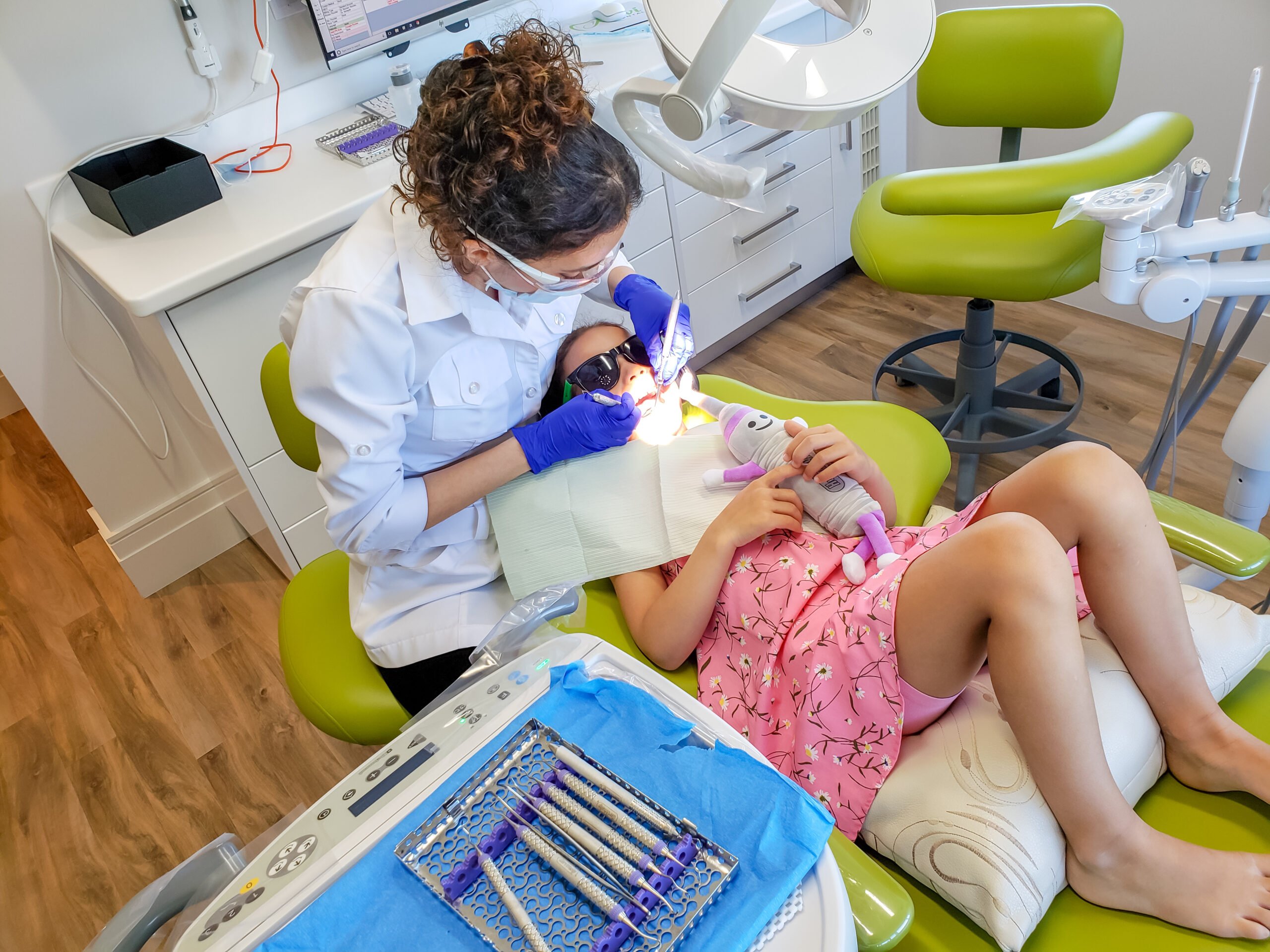 Dr Nourian doing a dental exam on a kid.
