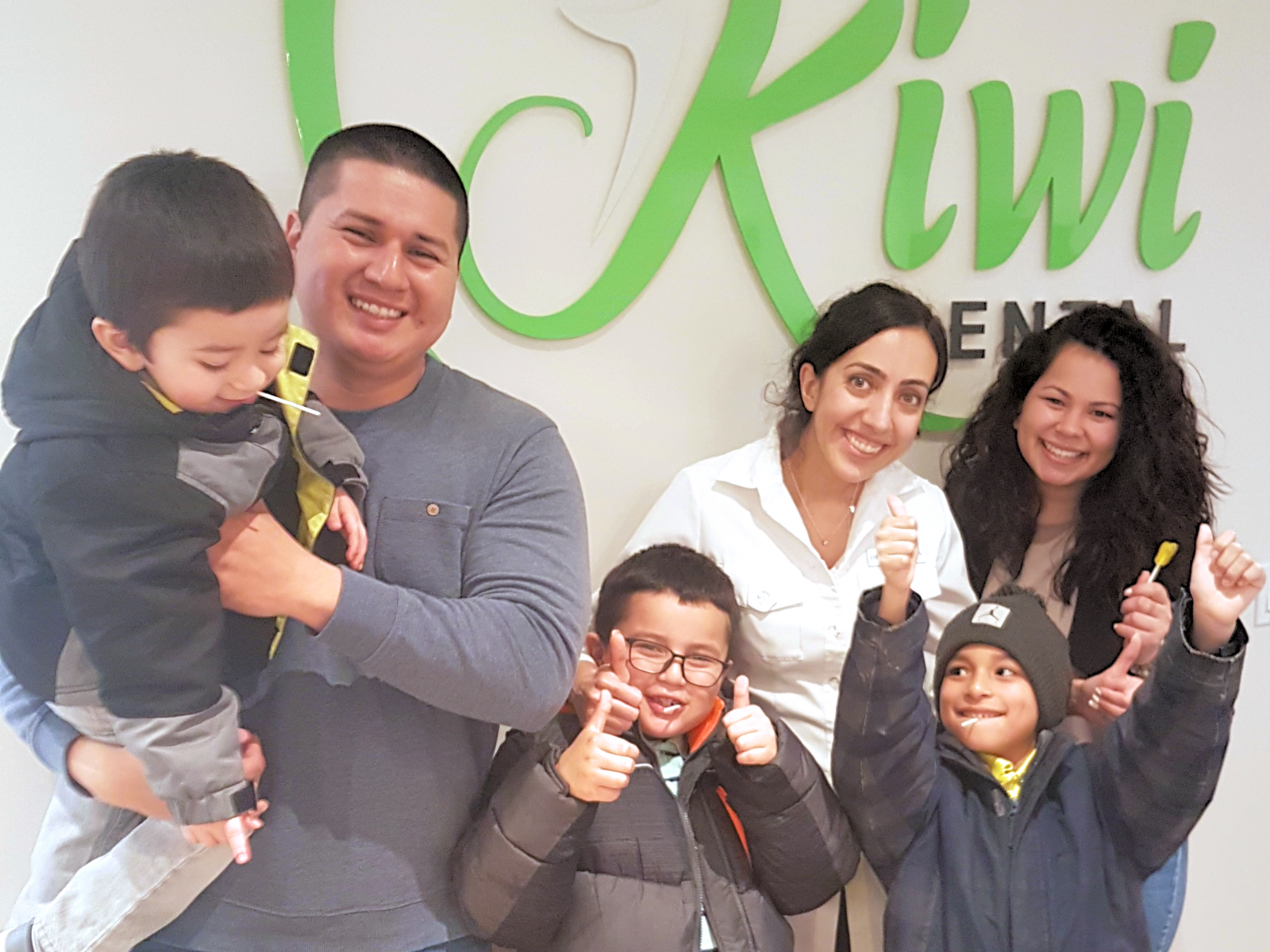 Dr Nourian with a family at Kiwi Dental Office